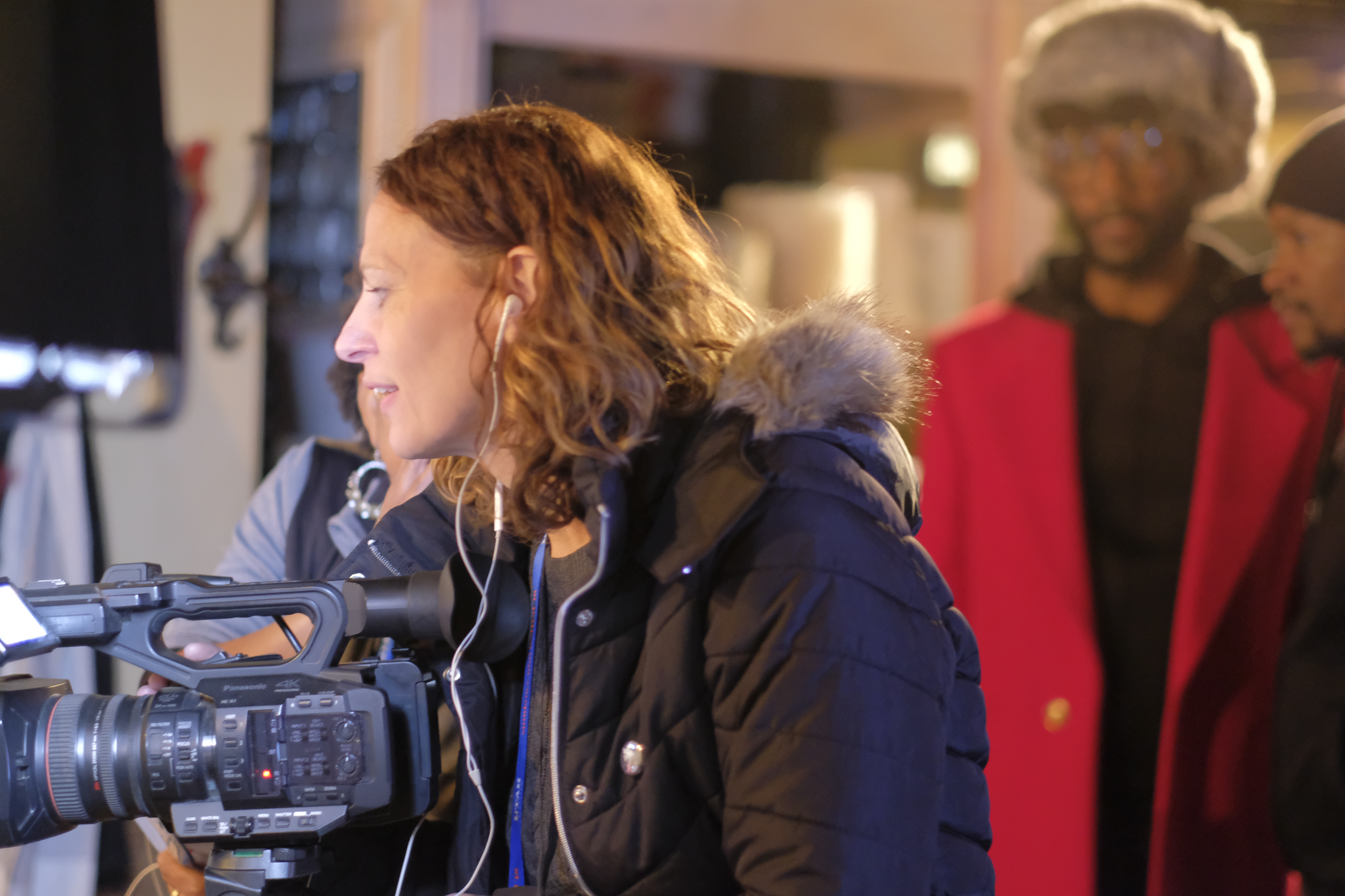Film crew working beside a camera on set